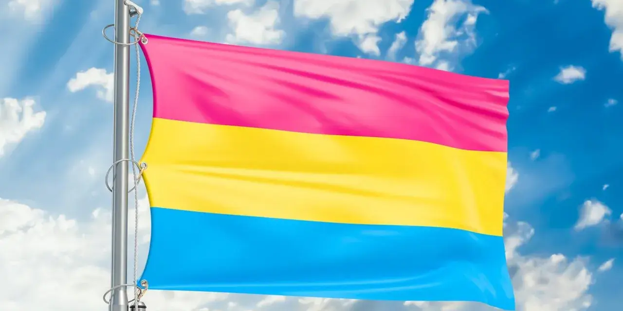 Flaga panseksualna powiewa na tle błękitnego nieba z chmurami. Symbolizuje miłość do wszystkich płci, bo co to pansexual.